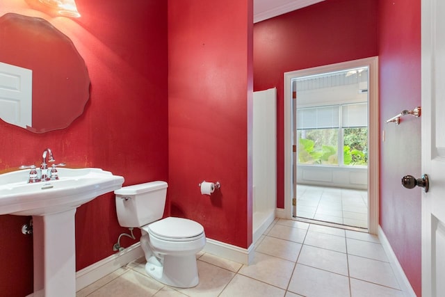 bathroom featuring toilet and tile patterned flooring