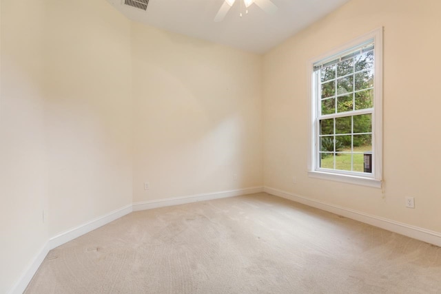 spare room with light colored carpet and ceiling fan