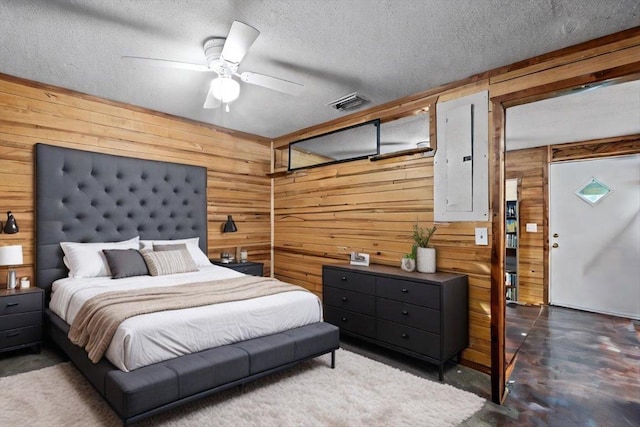 2056 N Sam Poppell Rd, Perry, FL 32347 - bedroom featuring wood walls, a textured ceiling, finished concrete flooring, and ceiling fan