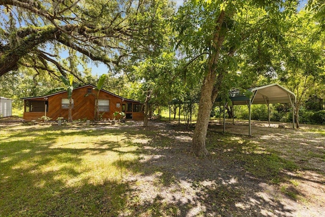 2056 N Sam Poppell Rd, Perry, FL 32347 - view of yard with a carport and view of scattered trees