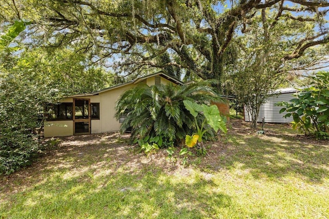 2056 N Sam Poppell Rd, Perry, FL 32347 - view of green lawn with a sunroom