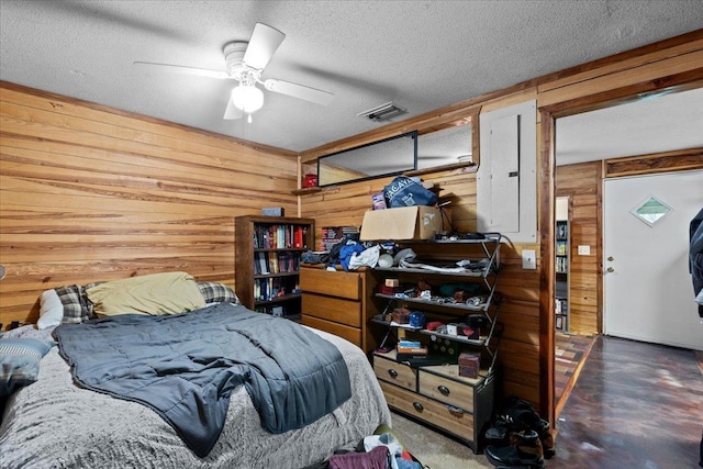 2056 N Sam Poppell Rd, Perry, FL 32347 - bedroom with wood walls, a textured ceiling, electric panel, and concrete floors