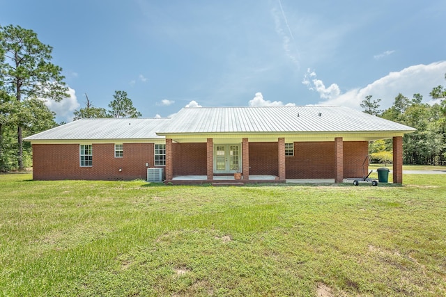 back of property with a lawn and cooling unit