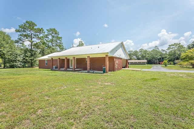 view of side of property with a yard