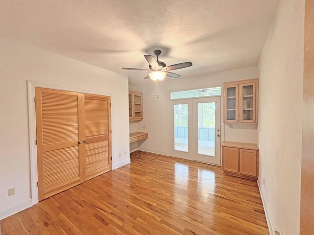 interior space featuring ceiling fan, french doors, and light wood-type flooring