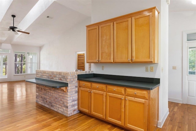 kitchen featuring light wood-type flooring, ceiling fan, and lofted ceiling