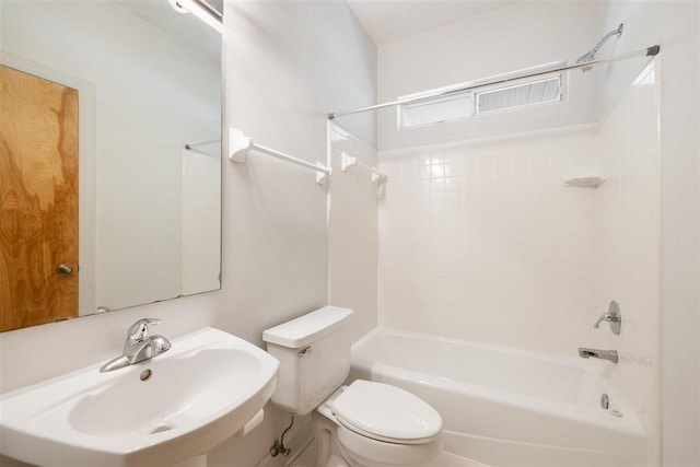 full bathroom featuring tiled shower / bath combo, toilet, and sink