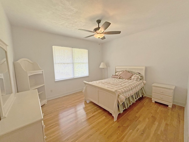 bedroom with ceiling fan and light wood-type flooring