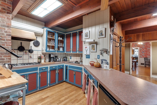 kitchen featuring wooden ceiling, beamed ceiling, light hardwood / wood-style floors, and stainless steel gas cooktop