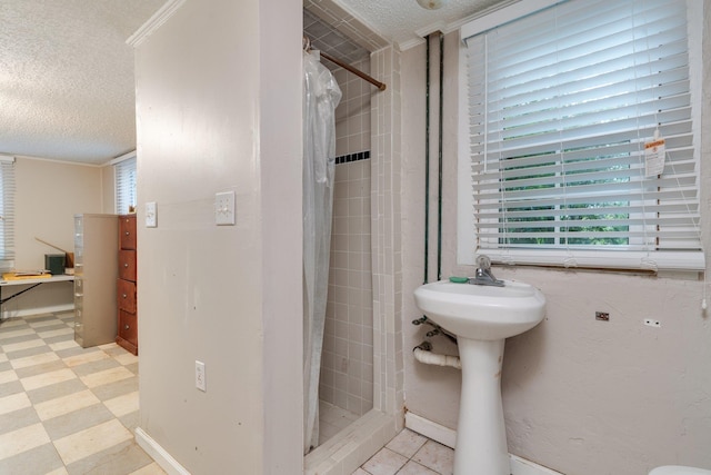 bathroom featuring ornamental molding, a textured ceiling, and a shower with shower curtain