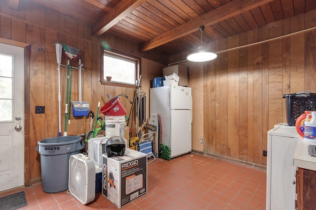 kitchen featuring wooden walls, beamed ceiling, and white fridge