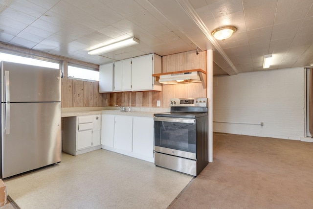 kitchen featuring sink, white cabinetry, premium range hood, and appliances with stainless steel finishes