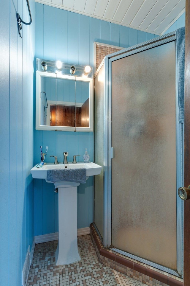 bathroom with tile patterned floors and a shower with shower door