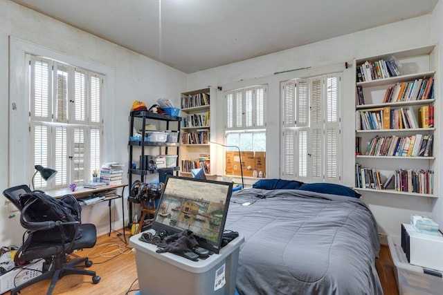 bedroom with hardwood / wood-style flooring