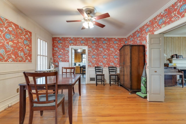 dining room with ceiling fan, light hardwood / wood-style floors, and ornamental molding