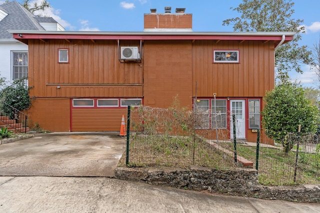 view of front of house featuring ac unit and a garage