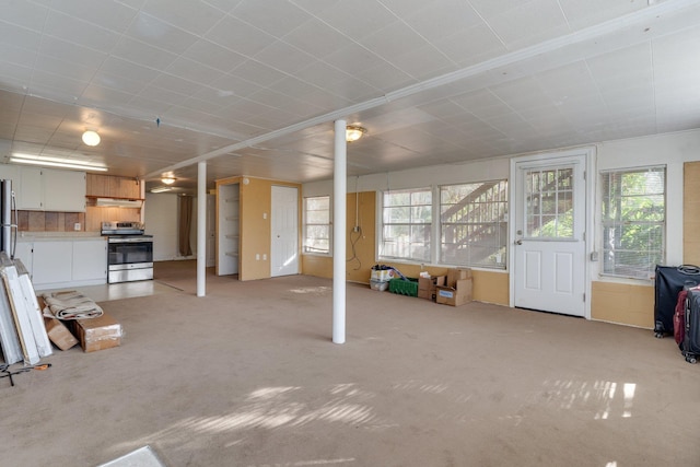 unfurnished living room featuring light carpet