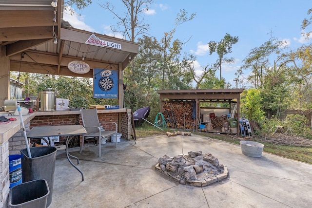 view of patio with a bar and an outdoor fire pit