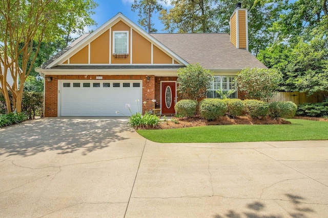 2031 Windsor Oaks Ct, Tallahassee, FL 32308 - view of front of home featuring a chimney, brick siding, concrete driveway, a garage, and roof with shingles