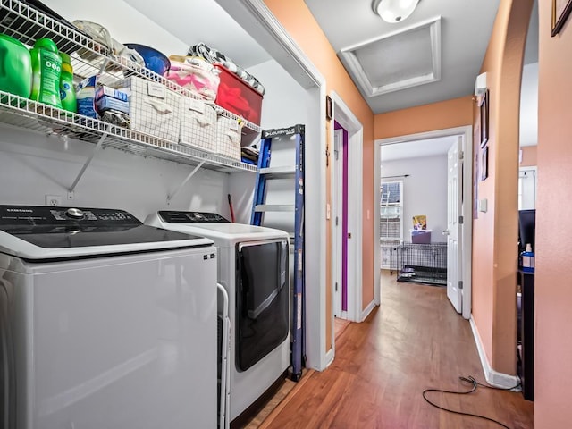 washroom featuring washer and dryer and wood-type flooring