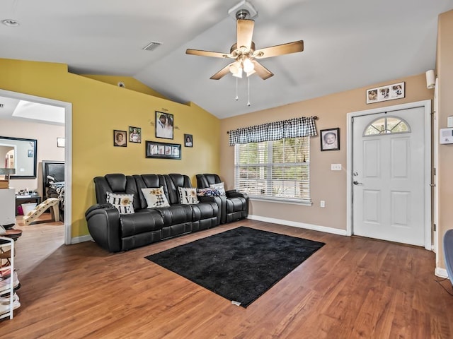 living room with ceiling fan, vaulted ceiling, and hardwood / wood-style flooring