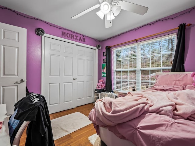 bedroom with wood-type flooring, a closet, and ceiling fan