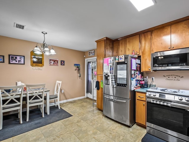 kitchen featuring a chandelier, appliances with stainless steel finishes, and pendant lighting