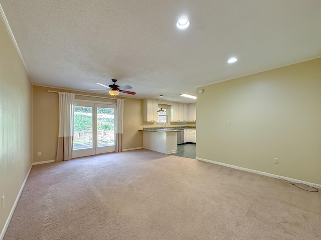 unfurnished living room with recessed lighting, baseboards, a textured ceiling, and light colored carpet