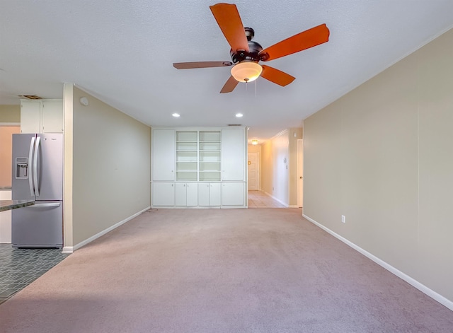 unfurnished living room featuring baseboards, recessed lighting, and light colored carpet