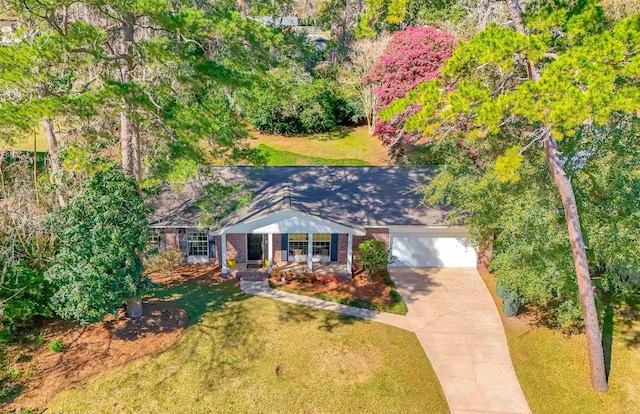 view of front of house featuring concrete driveway, brick siding, an attached garage, and a front lawn