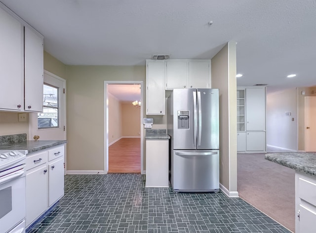 kitchen featuring white cabinets, stainless steel refrigerator with ice dispenser, baseboards, and white electric range oven