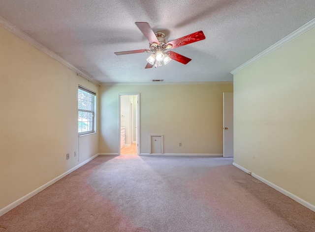 carpeted empty room with baseboards, visible vents, ceiling fan, ornamental molding, and a textured ceiling