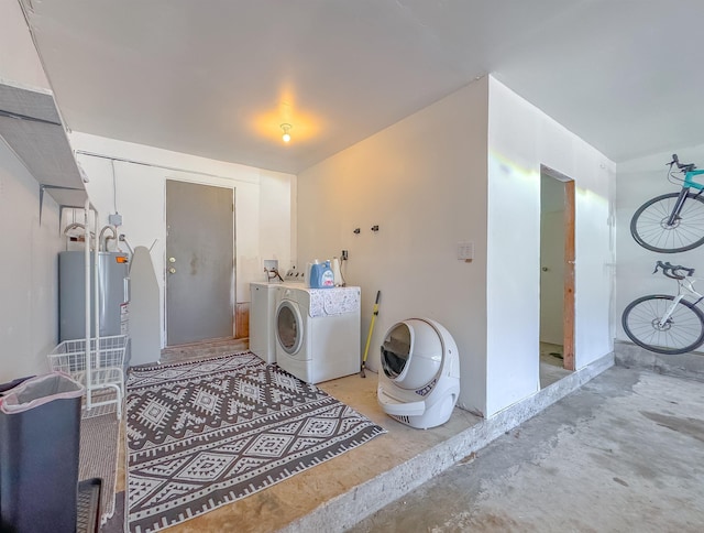 laundry room with washer and dryer, laundry area, and electric water heater