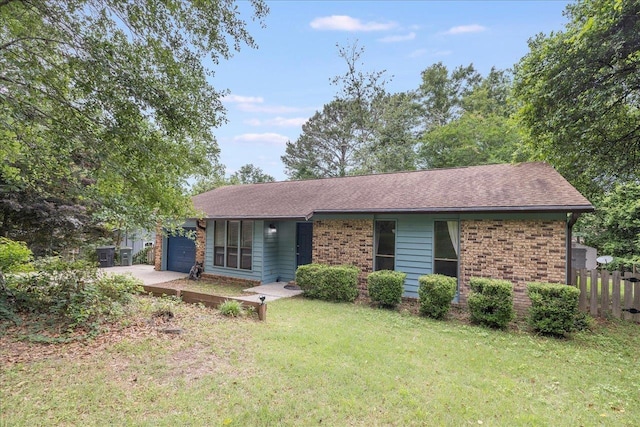 ranch-style home with brick siding, a garage, and a shingled roof
