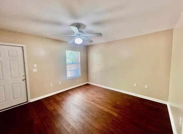 spare room with ceiling fan and dark hardwood / wood-style flooring