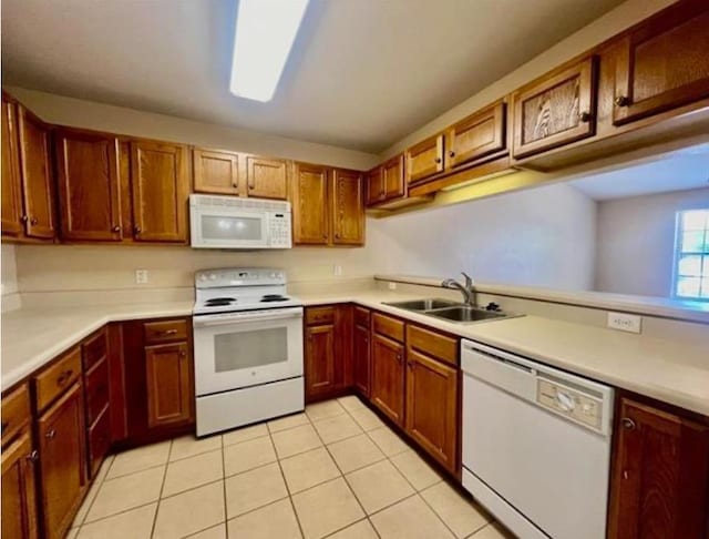 kitchen with sink, white appliances, and light tile patterned floors