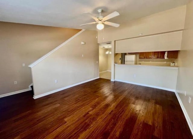 unfurnished living room with ceiling fan and dark wood-type flooring