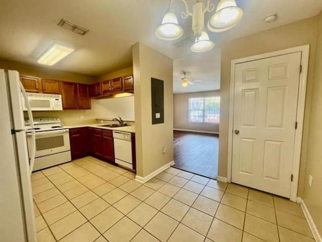 kitchen featuring white appliances, light tile patterned floors, sink, decorative light fixtures, and ceiling fan with notable chandelier