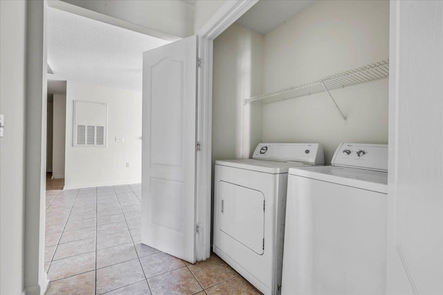 3000 S Adams St Unit 113, Tallahassee, FL 32301 - laundry room featuring washing machine and dryer and light tile patterned flooring