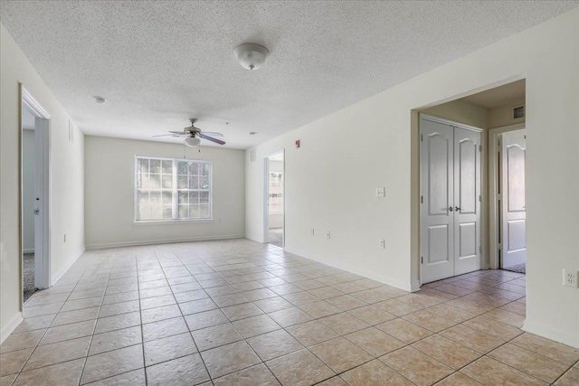 3000 S Adams St Unit 113, Tallahassee, FL 32301 - spare room with ceiling fan, light tile patterned flooring, a textured ceiling, and baseboards