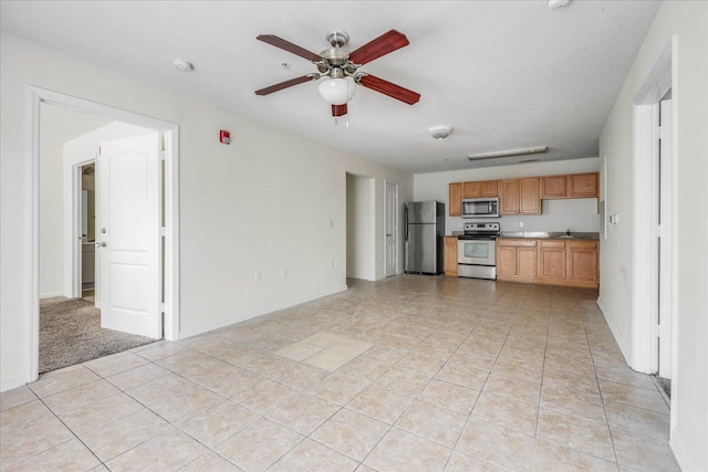 3000 S Adams St Unit 113, Tallahassee, FL 32301 - kitchen with appliances with stainless steel finishes, ceiling fan, a sink, light tile patterned flooring, and baseboards