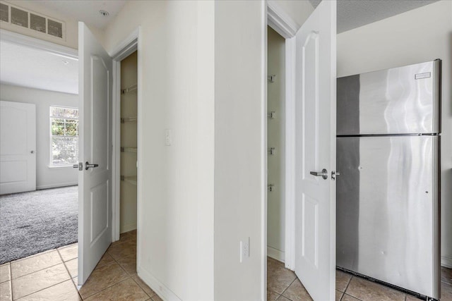 3000 S Adams St Unit 113, Tallahassee, FL 32301 - hall featuring light tile patterned flooring and light carpet