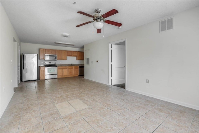 3000 S Adams St Unit 113, Tallahassee, FL 32301 - kitchen featuring appliances with stainless steel finishes, ceiling fan, light tile patterned flooring, and baseboards