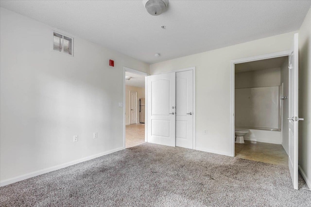 3000 S Adams St Unit 113, Tallahassee, FL 32301 - unfurnished bedroom with carpet, baseboards, connected bathroom, and a closet