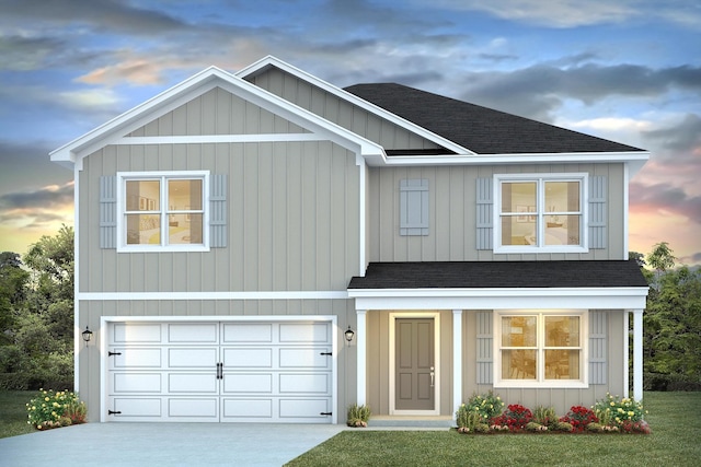 view of front of home with a garage and a yard