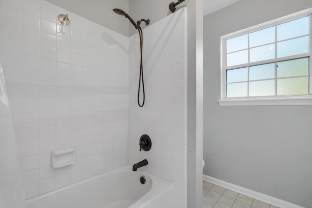 bathroom featuring tile patterned flooring and tiled shower / bath