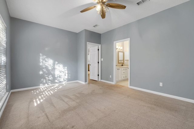 unfurnished bedroom with light carpet, ceiling fan, and ensuite bathroom