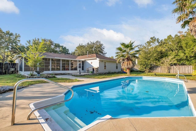 view of swimming pool featuring a sunroom