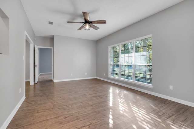 spare room with wood-type flooring and ceiling fan