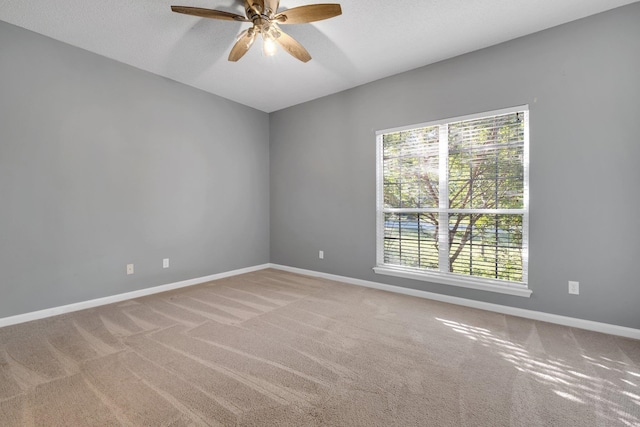 carpeted empty room featuring a textured ceiling and ceiling fan